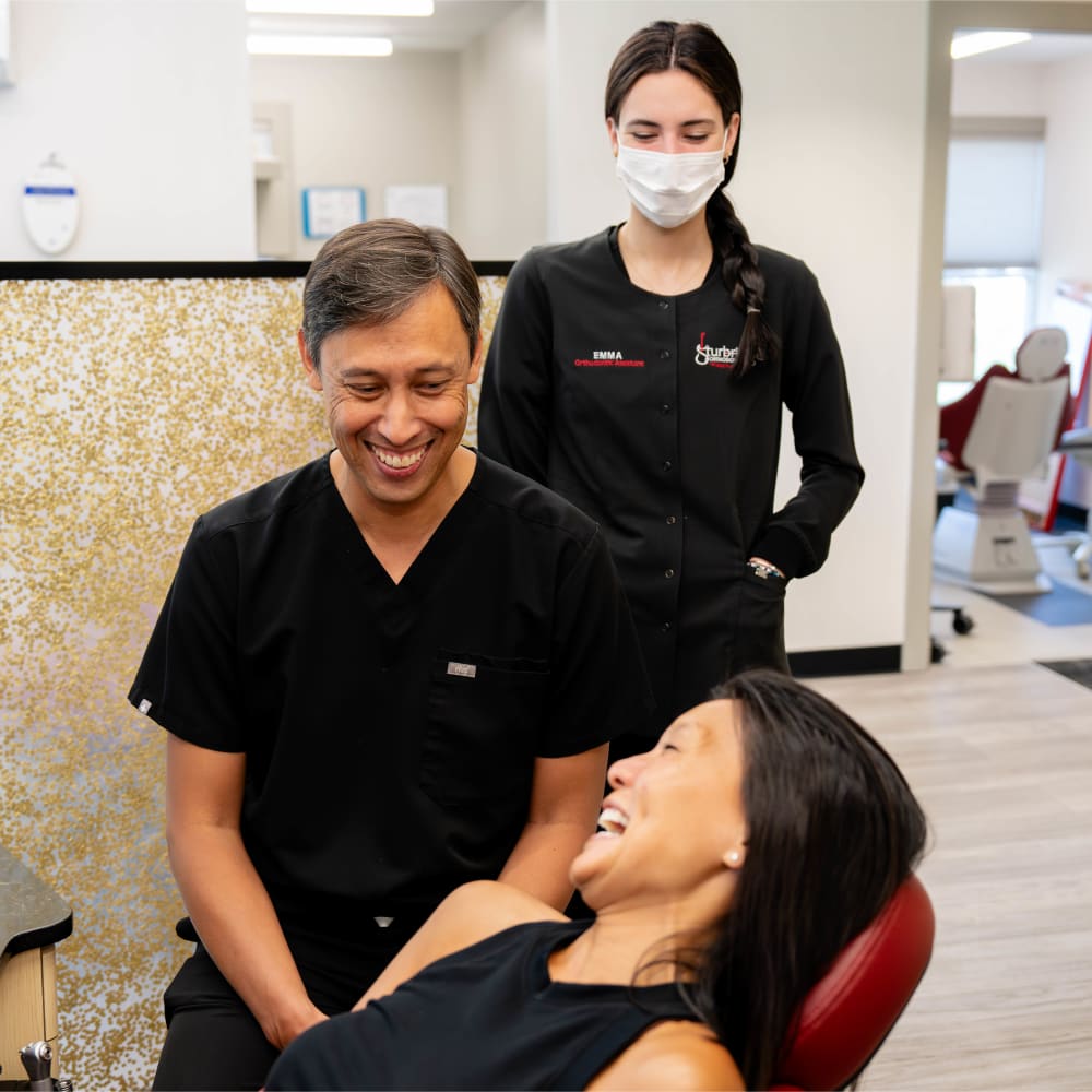 Dr. Sabelis and a team member help a patient at Sturbridge Orthodontics.