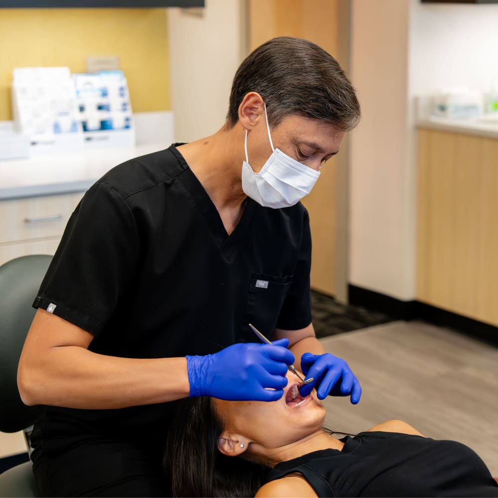 Dr. Sabelis performs an exam on an adult patient.