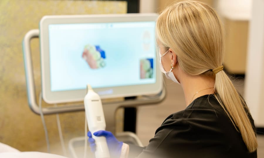 A team member at Sturbridge Orthodontics creates a 3D rendering of a patient's teeth using a scanner.