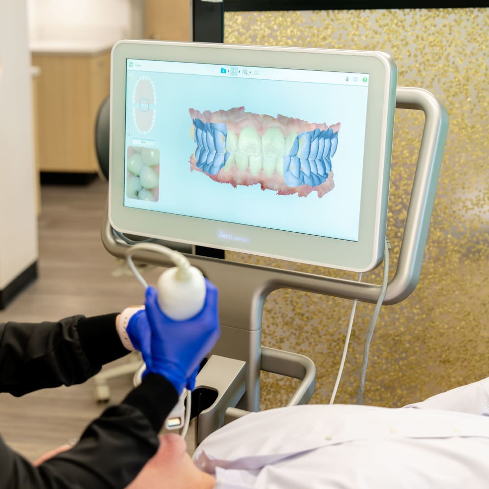 A team member at Sturbridge Orthodontics uses a scanner to make a 3D model of a patient's mouth.