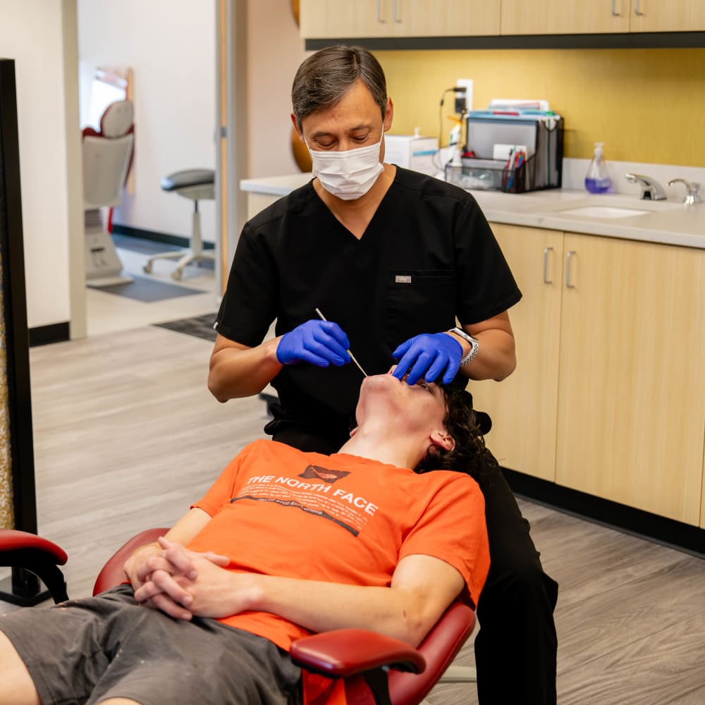 Dr. Sabelis performs an exam on a teenage patient.